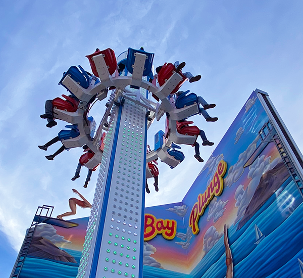 The Bay Plunge attraction with people on it up in the air