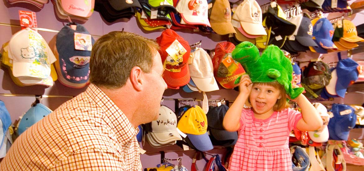 Child and father trying on hats at Krazy Kaps